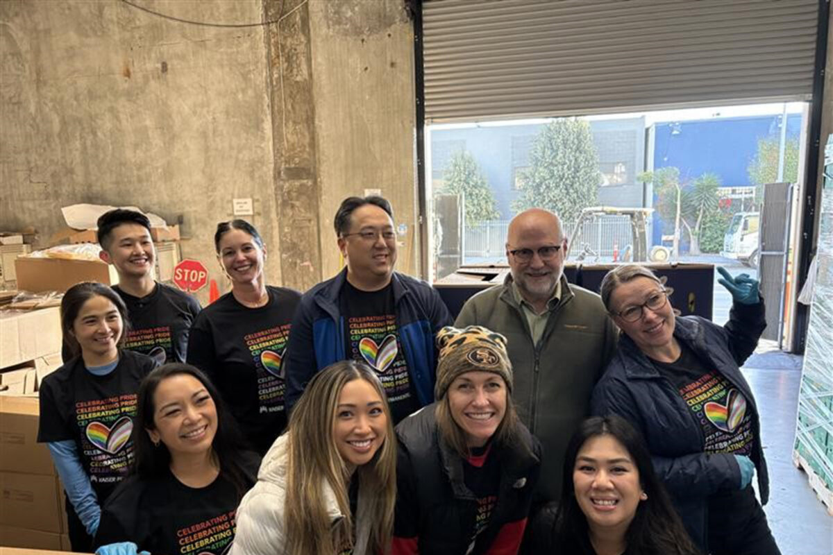 Group photo holding cardboard sign with #of bags, food weight