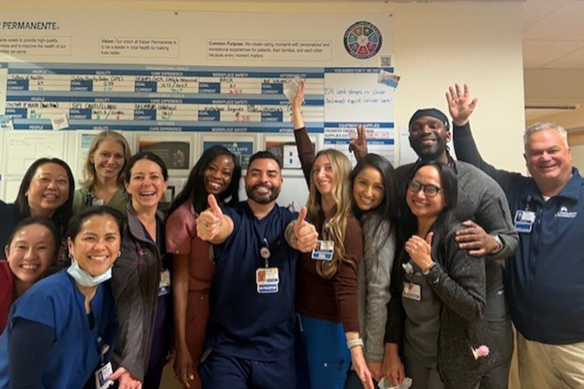 A group of CVICU nurses waving and giving a thumbs up in celebration of the Beacon Award.
