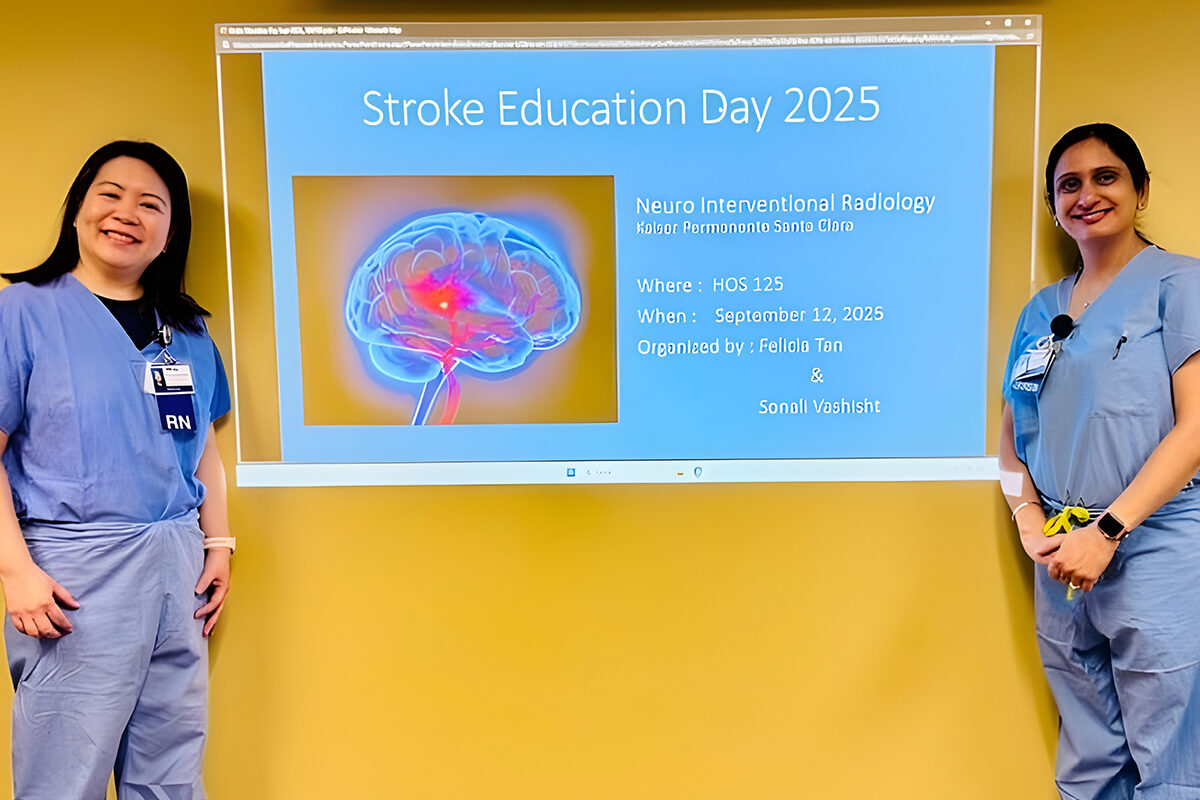 2 nurses standing in front of a Stroke Education Day 2025 presentation