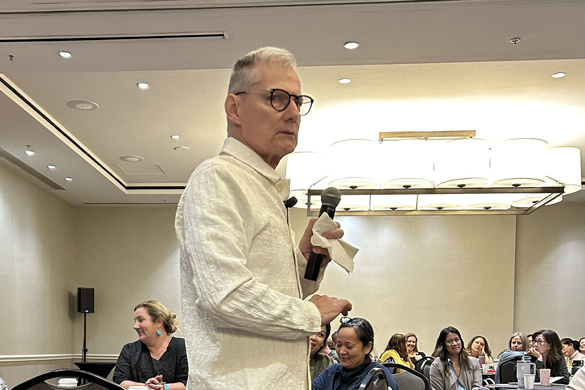 Tim Porter O'Grady speaking to a group of nurses in a conference room.