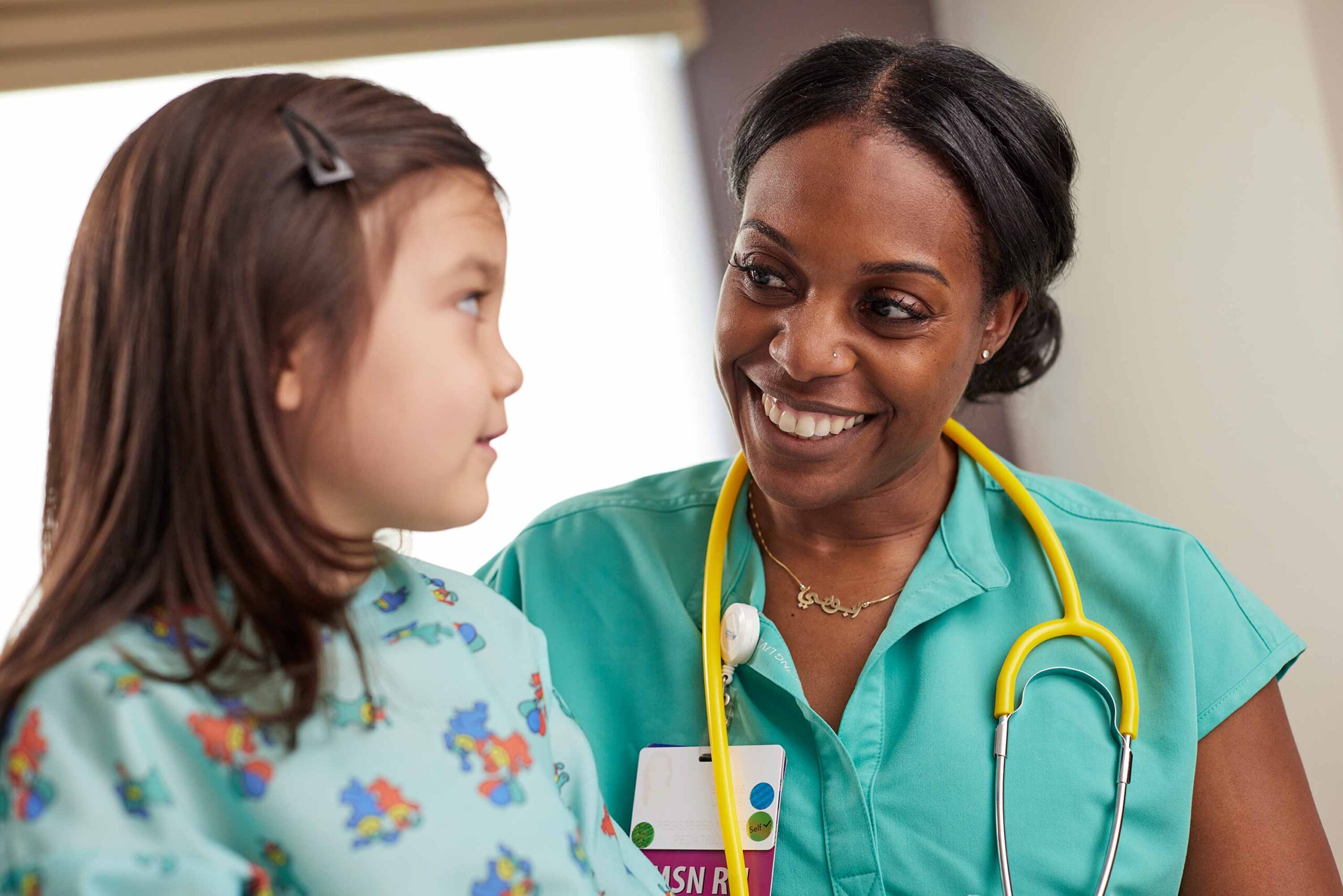 22Nurse_17328 Nurse performing an exam on a young patient