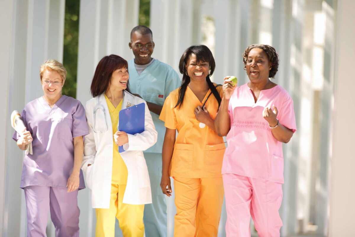 Group of happy Kaiser Permanente nurses enjoying a walk together