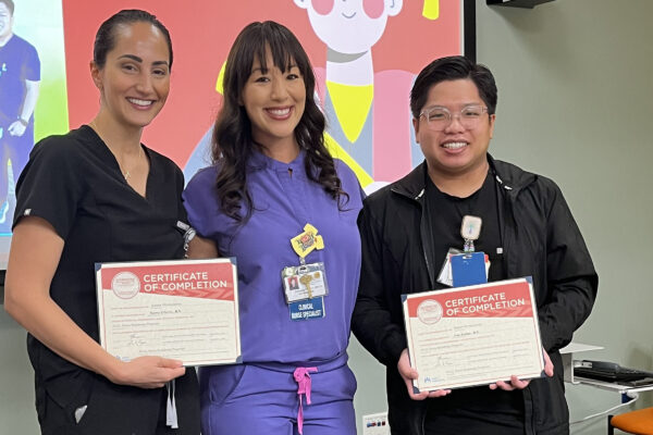 3 nurses smiling with certificates