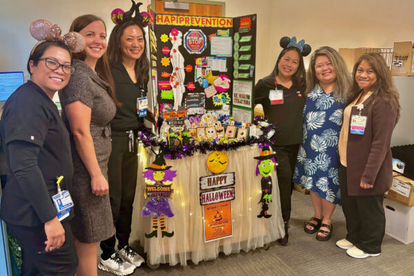 a group of nurses at a happy halloween table