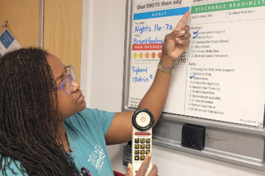 Alisha Thompson pointing to care board