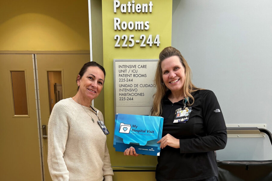 2 nurses holding a folder to improve communication.