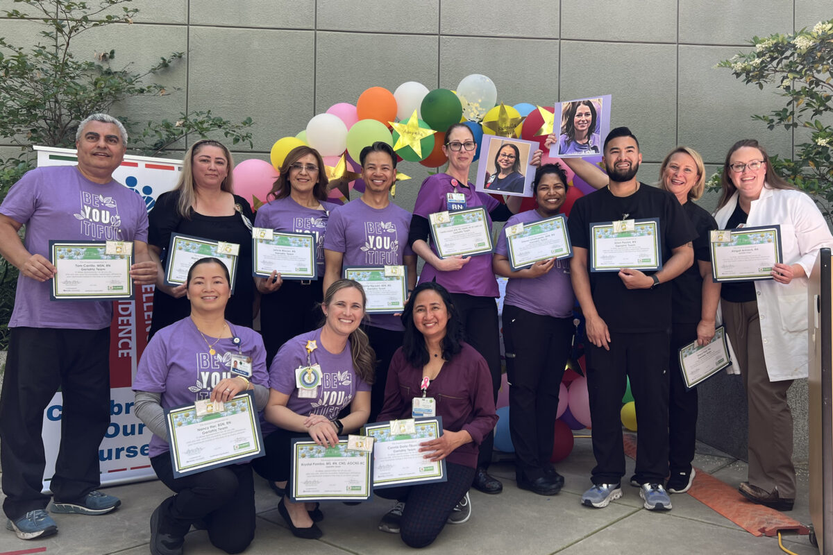 A large group of nurses holding awards