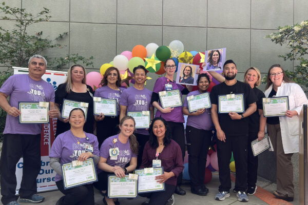 A large group of nurses holding awards