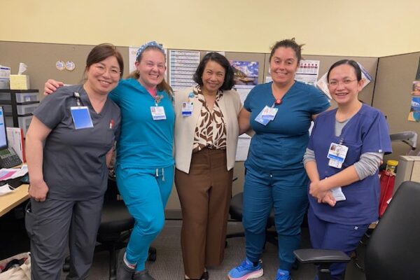 5 nurses smiling