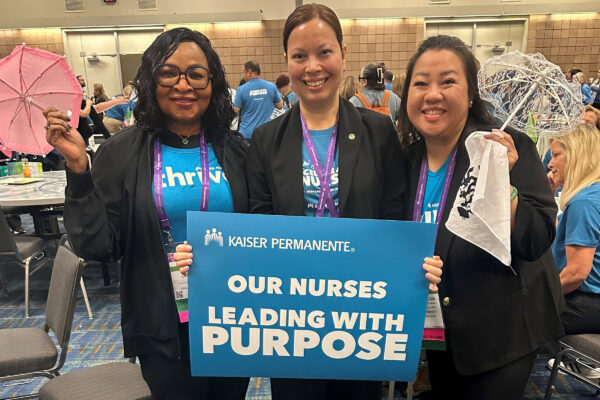 3 nurses with a sign