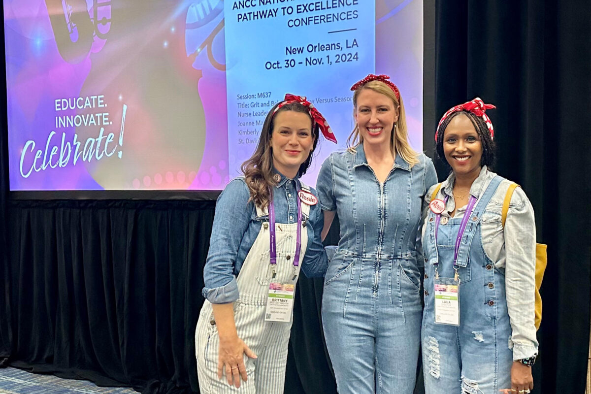 3 nurses dressed as Rosie the Riveter