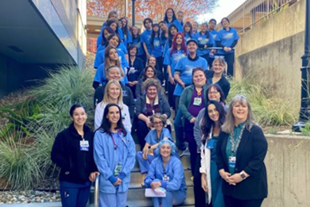A group of nurses posing on a staircase