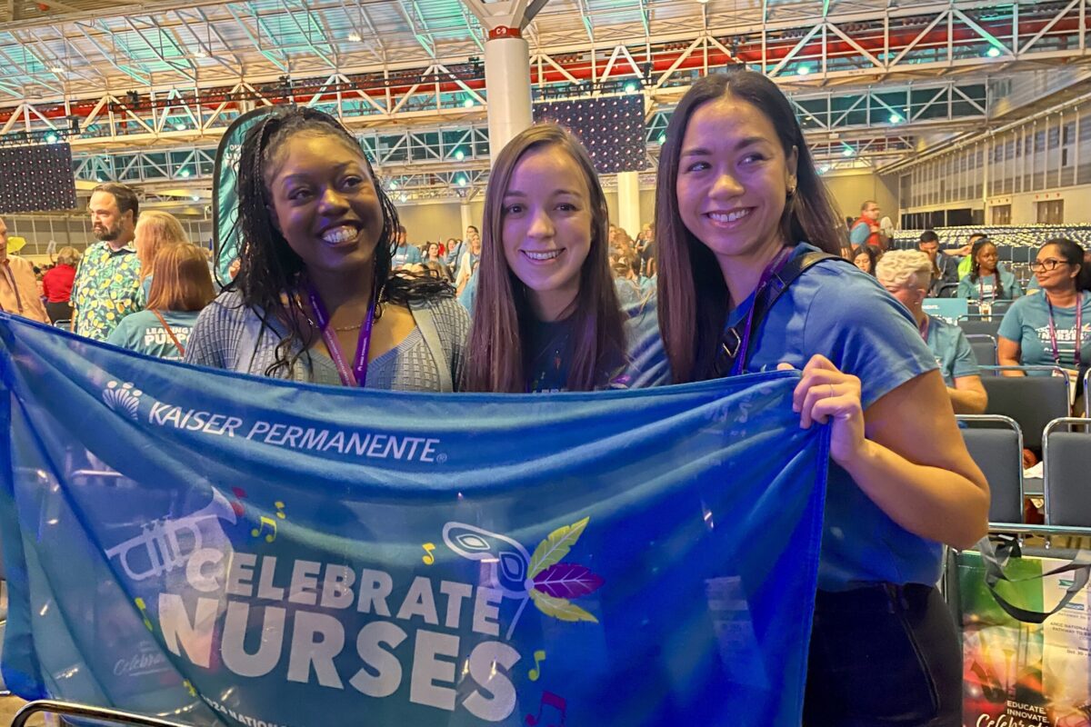 3 nurses smiling holding a banner that says Celebrate Nurses