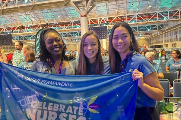 3 nurses smiling holding a banner that says Celebrate Nurses