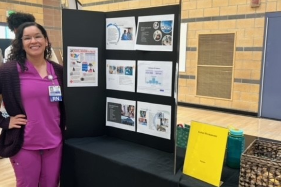 Nurse standing at poster