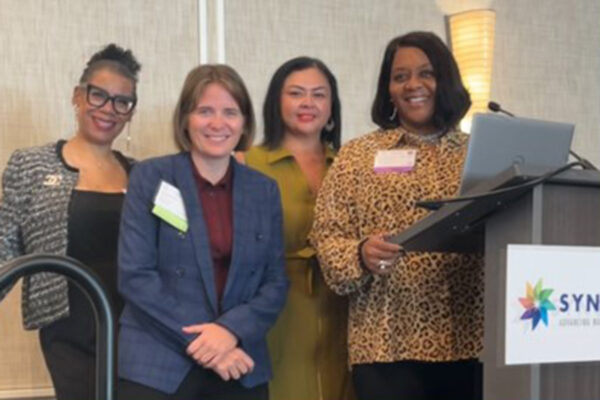 A group of nurses at a podium