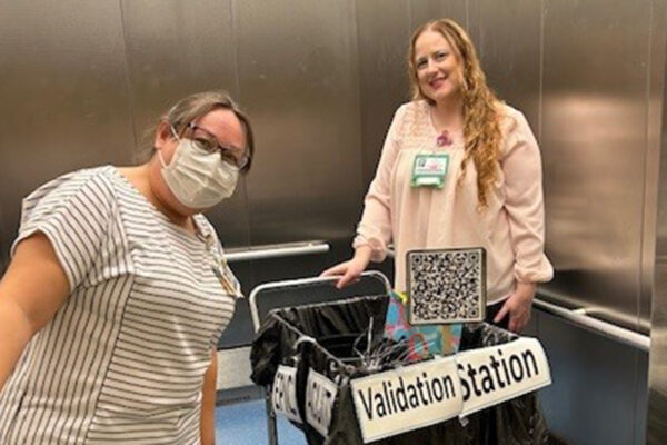 nurses in an elevator with a cart