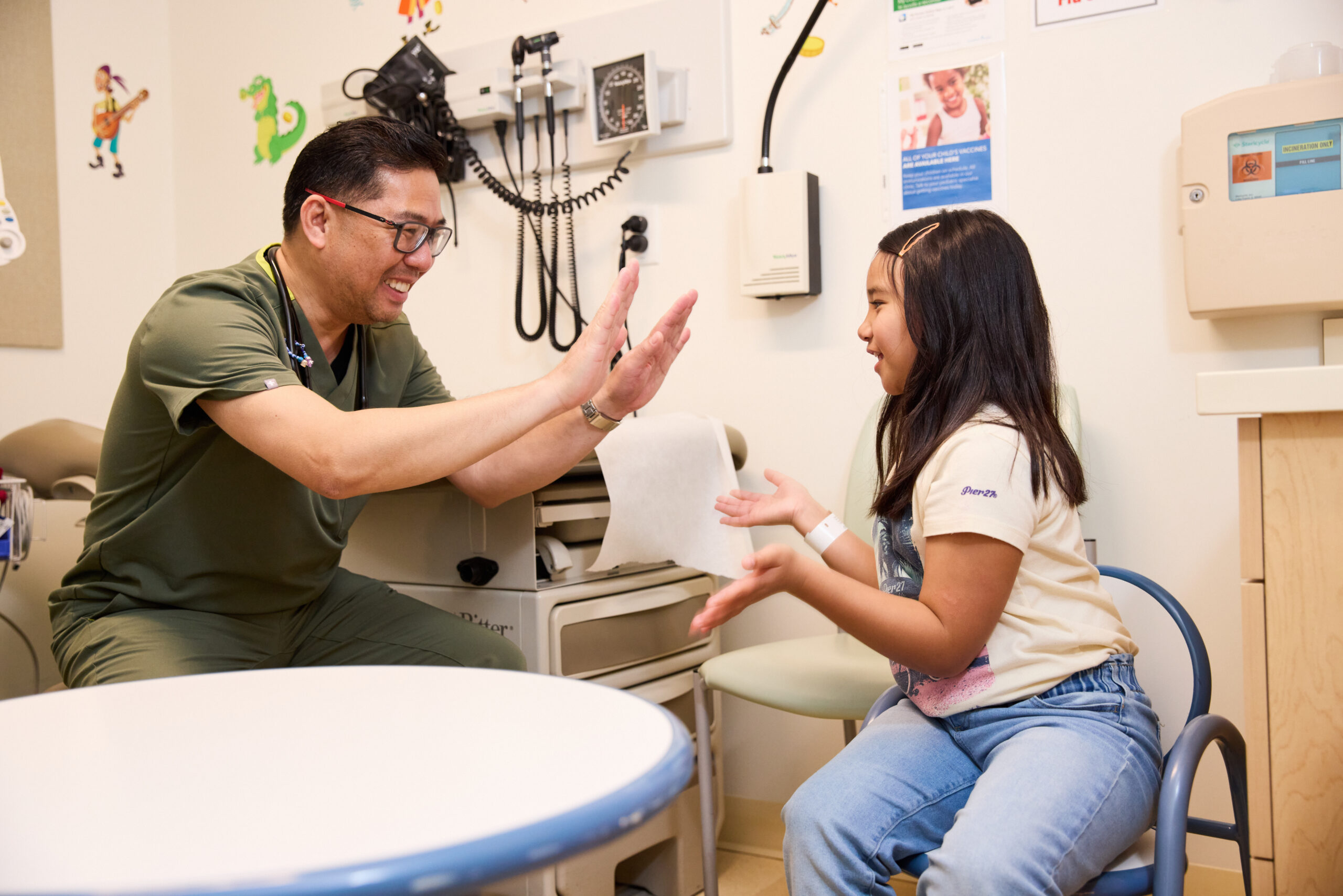 Nurse high fiving a young patient.