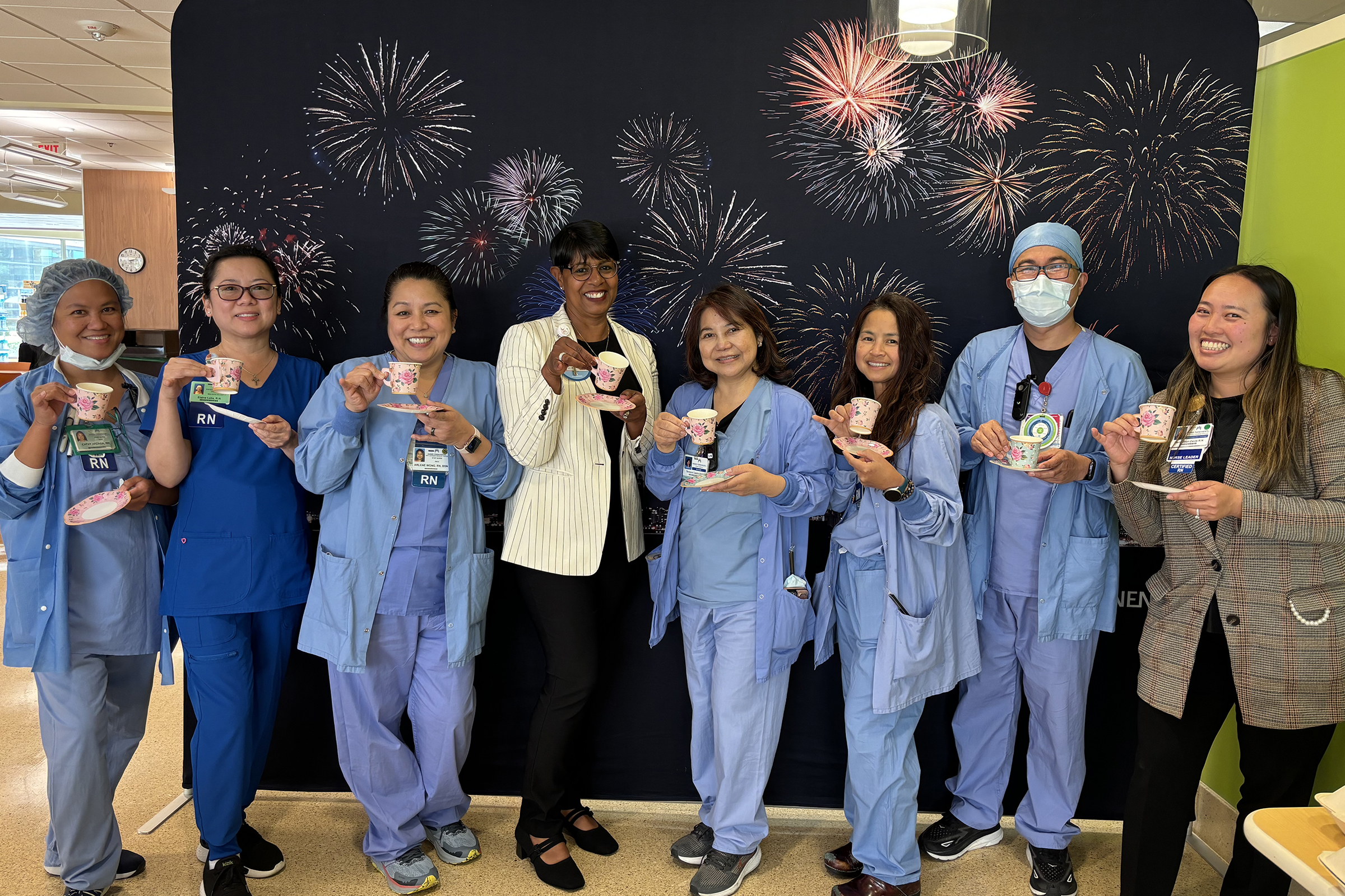 Sharon Hampton with a group of nurses holding tea cups.