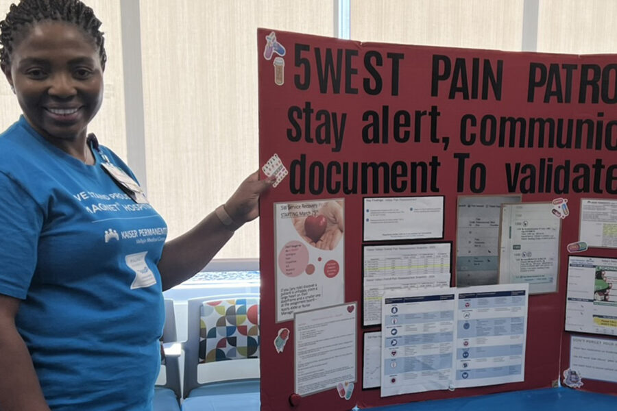 Glory Nwaoha in front of her poster.