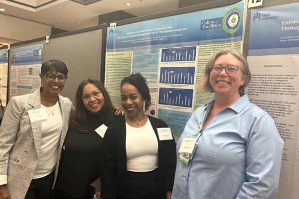 San Leandro nurses in front of a poster at the RIA conference.