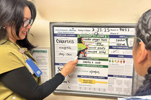 2 nurses at the patient communication board