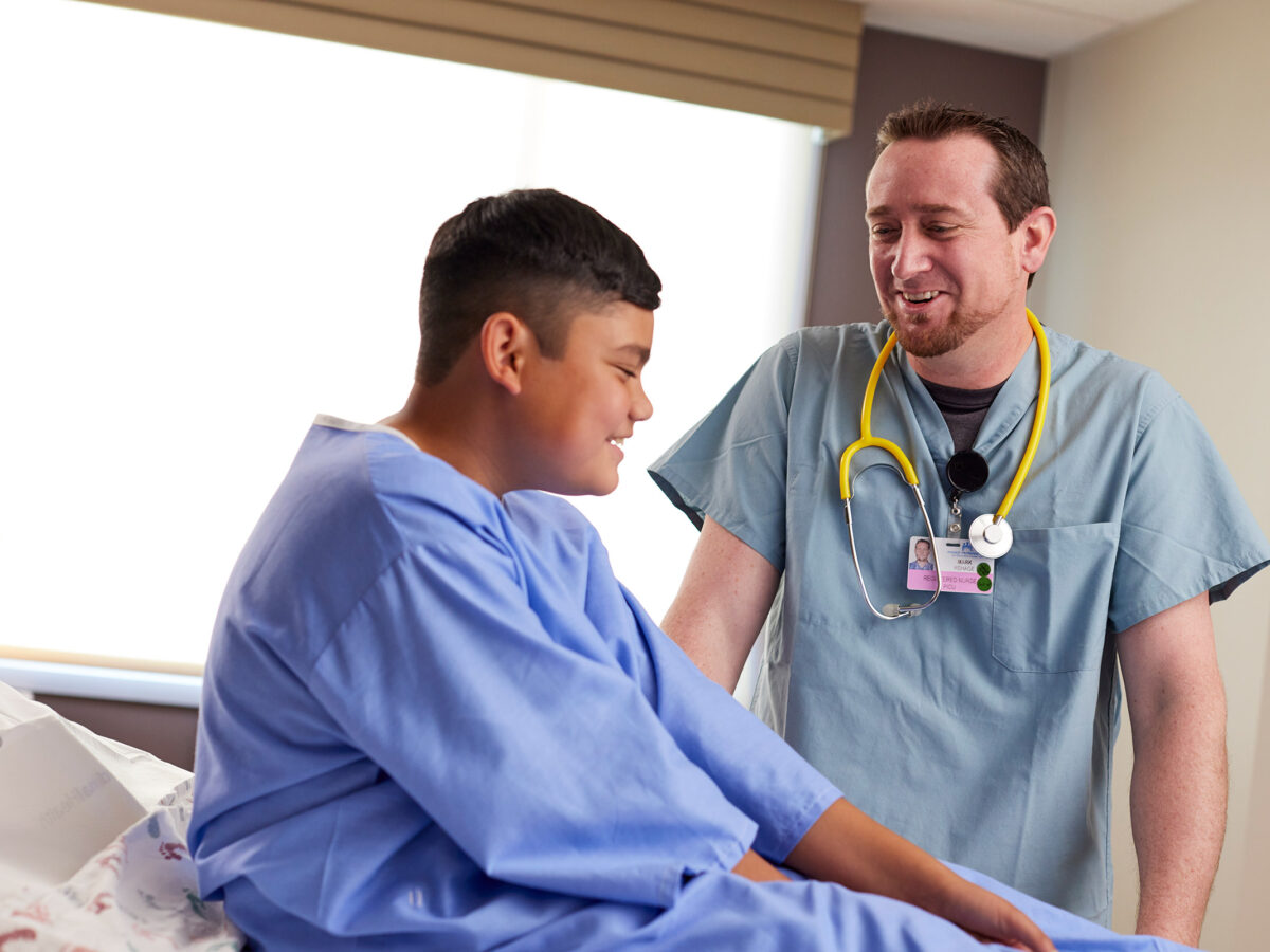 Male Nurse With Young Patient.