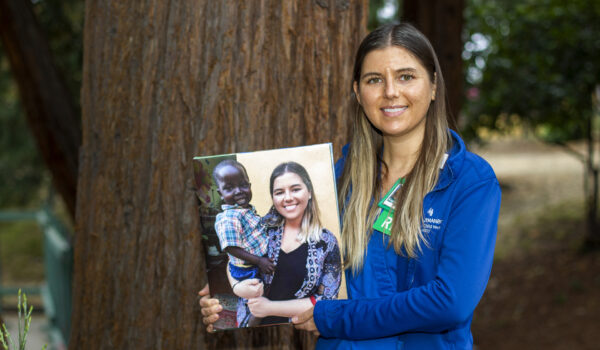 Kayla Billington, RN, With A Photo Of Her And Patrick, The Little Boy Who Died Of A Correctible Heart Defect And Who Inspired Her To Help Other Children In Uganda.