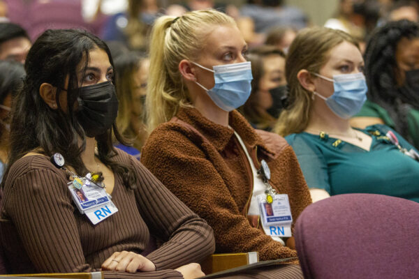 Rebecca Valencia, RN, at left, listens with other graduates to a presentation during the nurse residency graduation in May.
