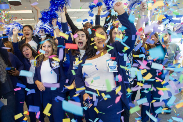 People cheering with confetti in the air.