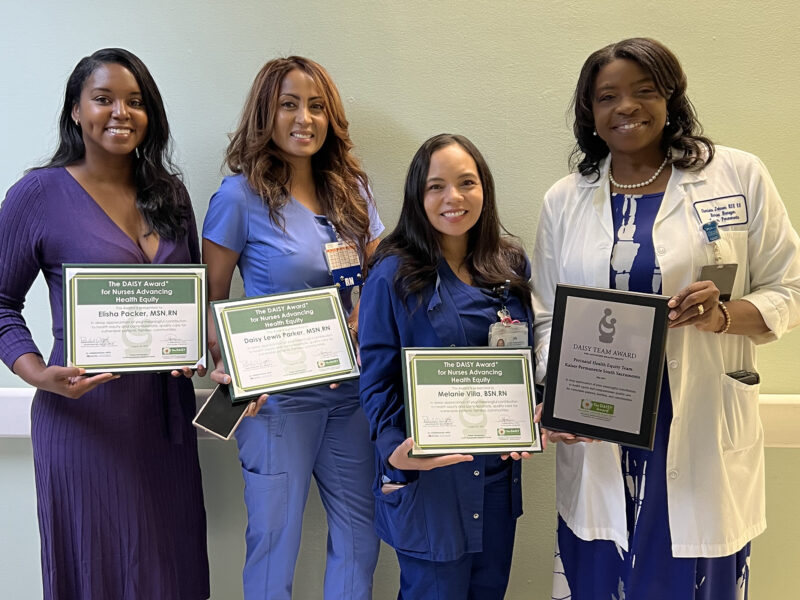 Four Nurses Smiling Holding An Award