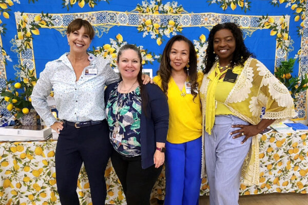 4 female nurses smiling