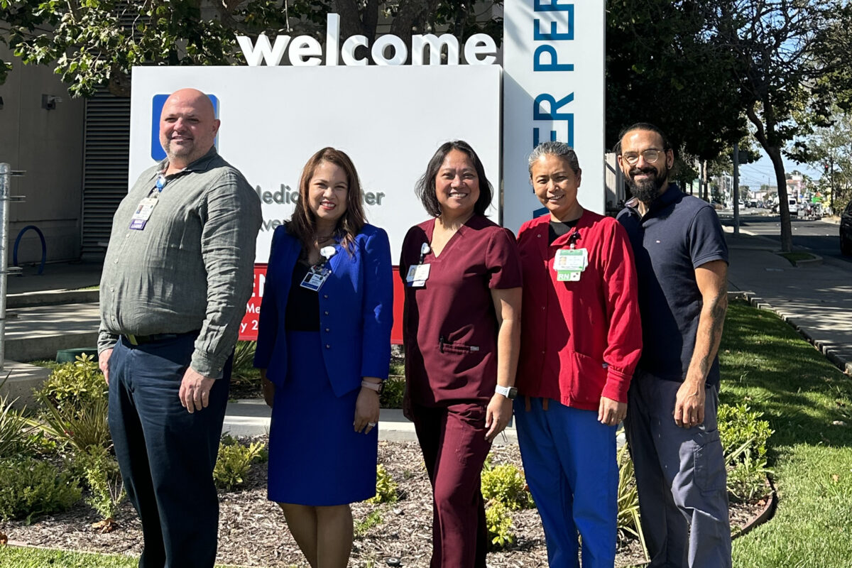 Group of 5 nurses standing and smiling