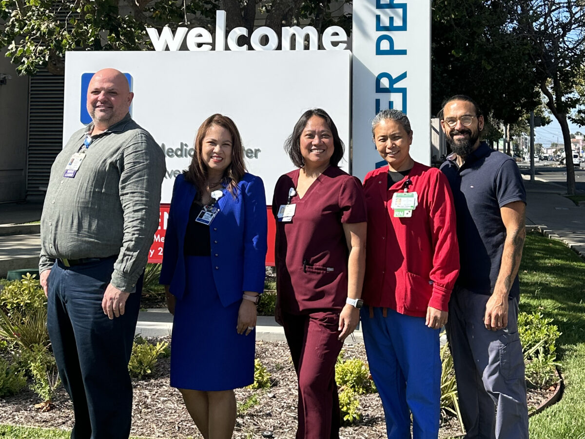 Group Of 5 Nurses Standing And Smiling