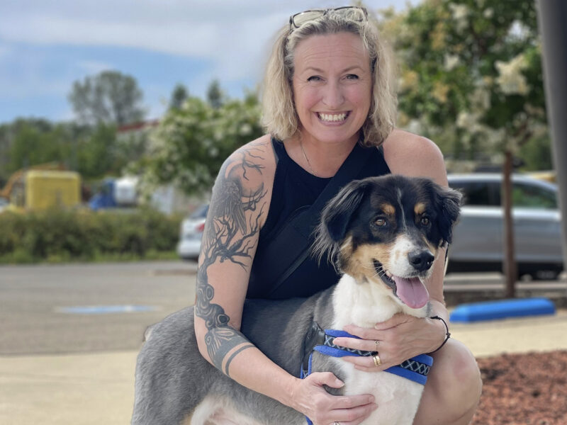 A Nurse Smiling With A Dog.