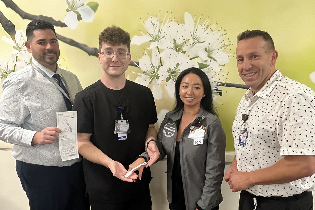 4 Nurses Smiling While Holding A Pulse Oximeter