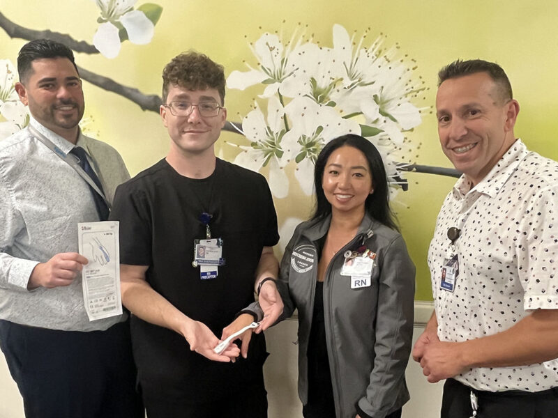 4 Nurses Smiling While Holding A Pulse Oximeter