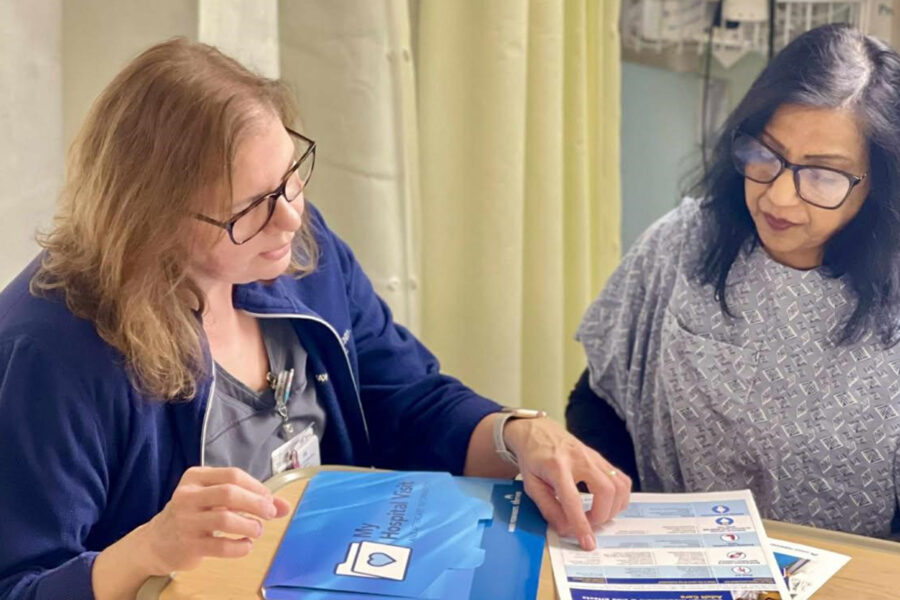 Nurse talking to a patient at the bedside