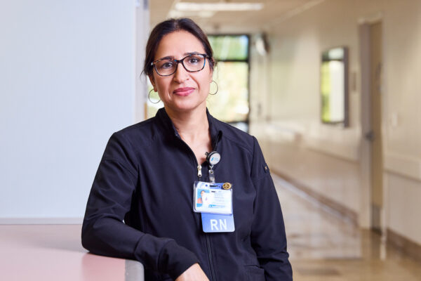 A nurse leaning up against the nurses station