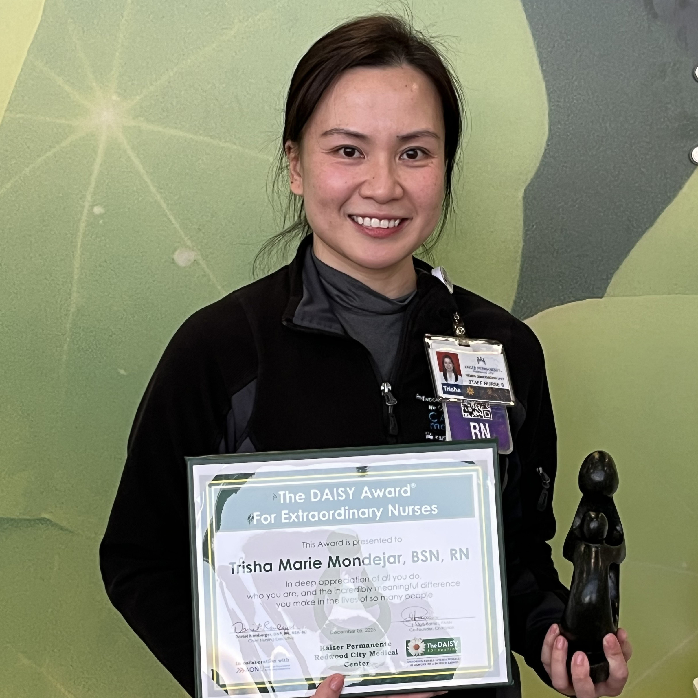 Trisha Mondejar holding a DAISY award