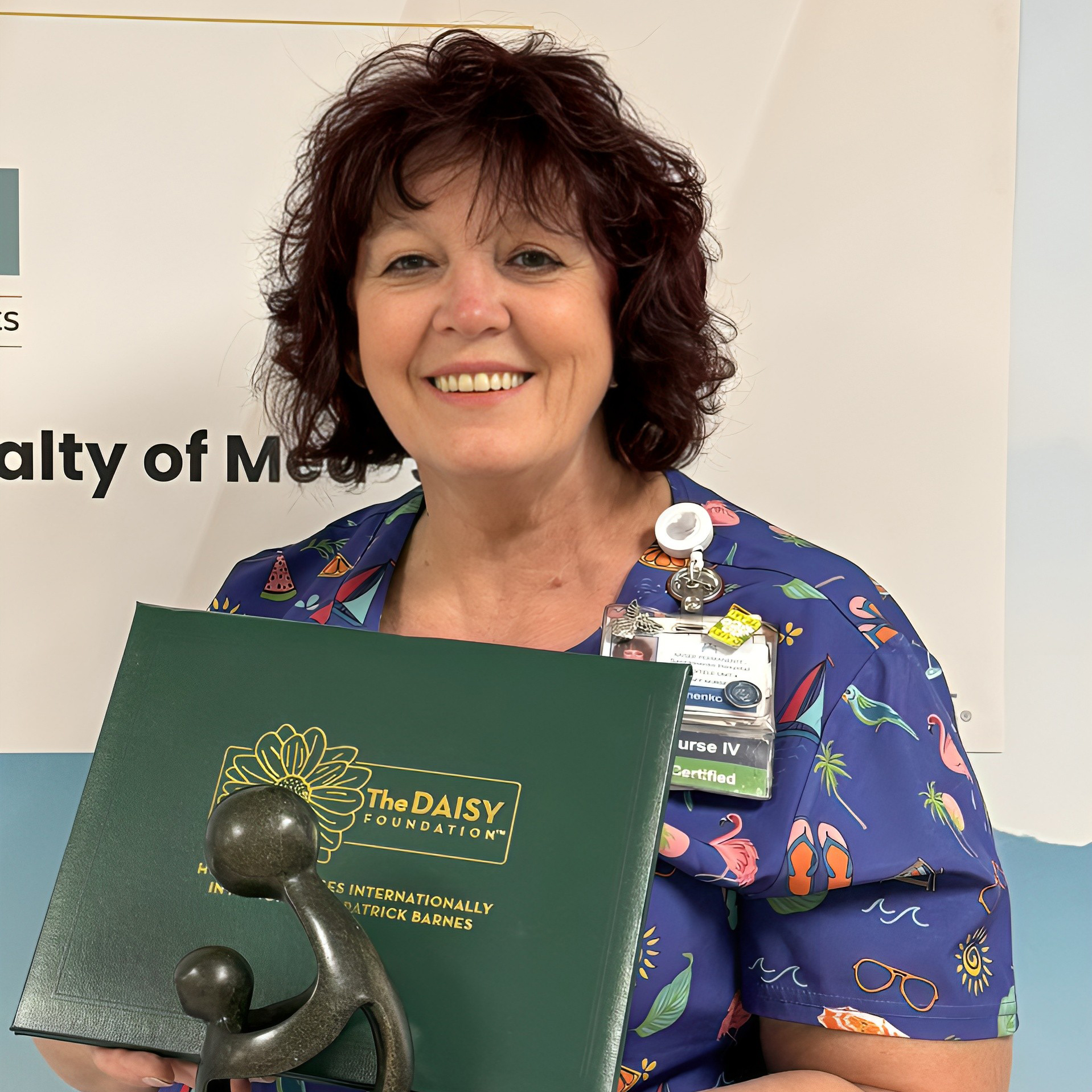 Ella Silchenko holding a DAISY award