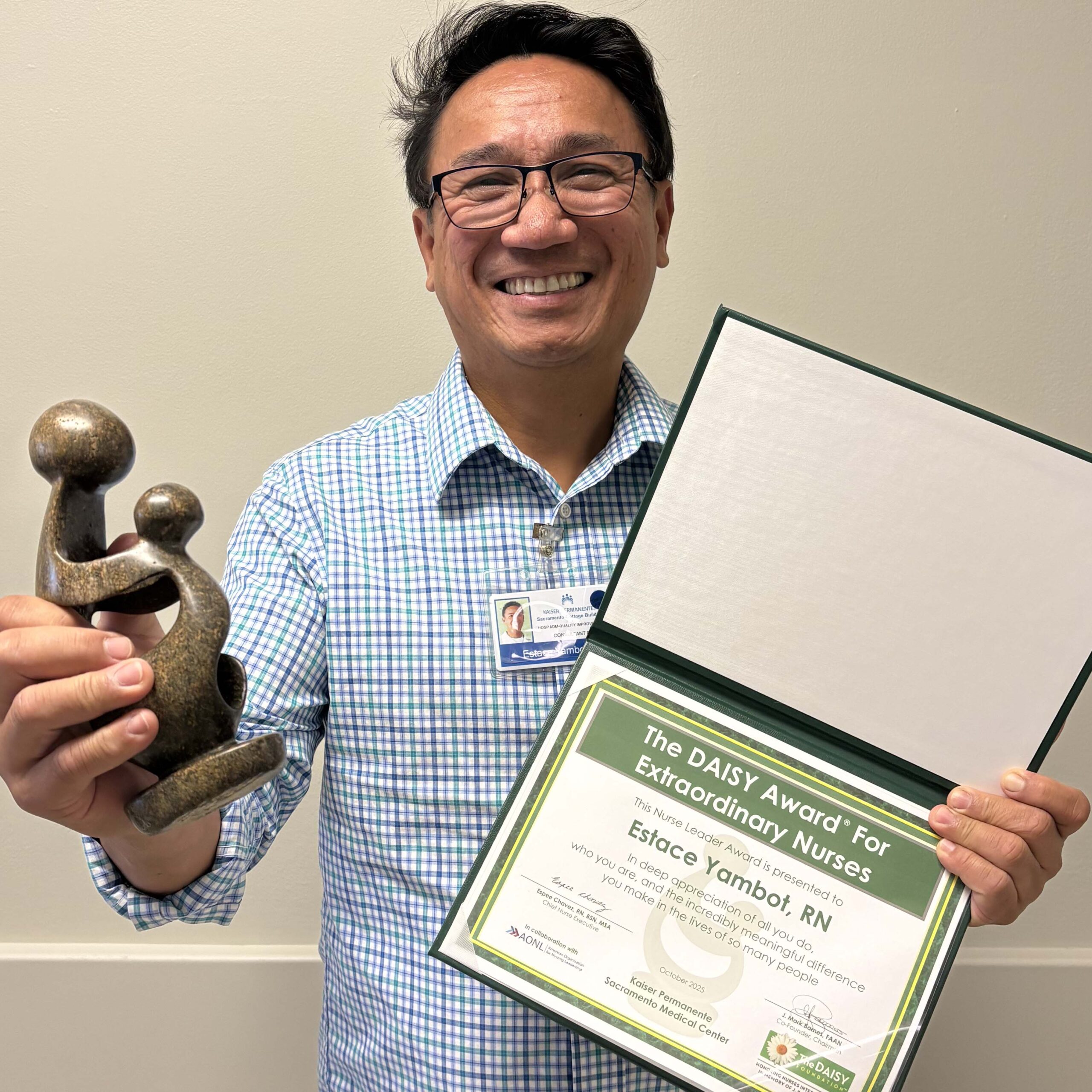 Estace Yambot holding a DAISY award