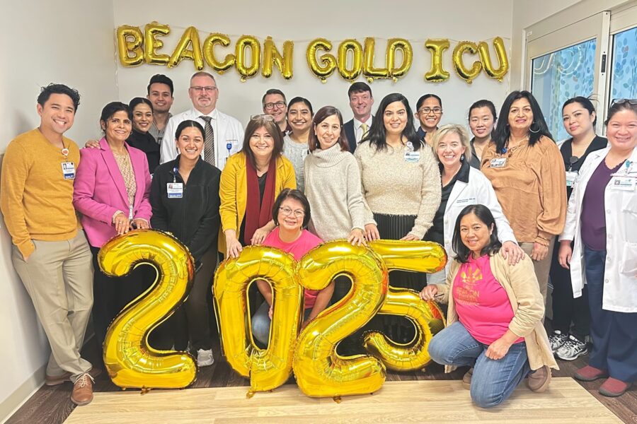 A group of nurses gathered with balloons that read Beacon Gold ICU 2025